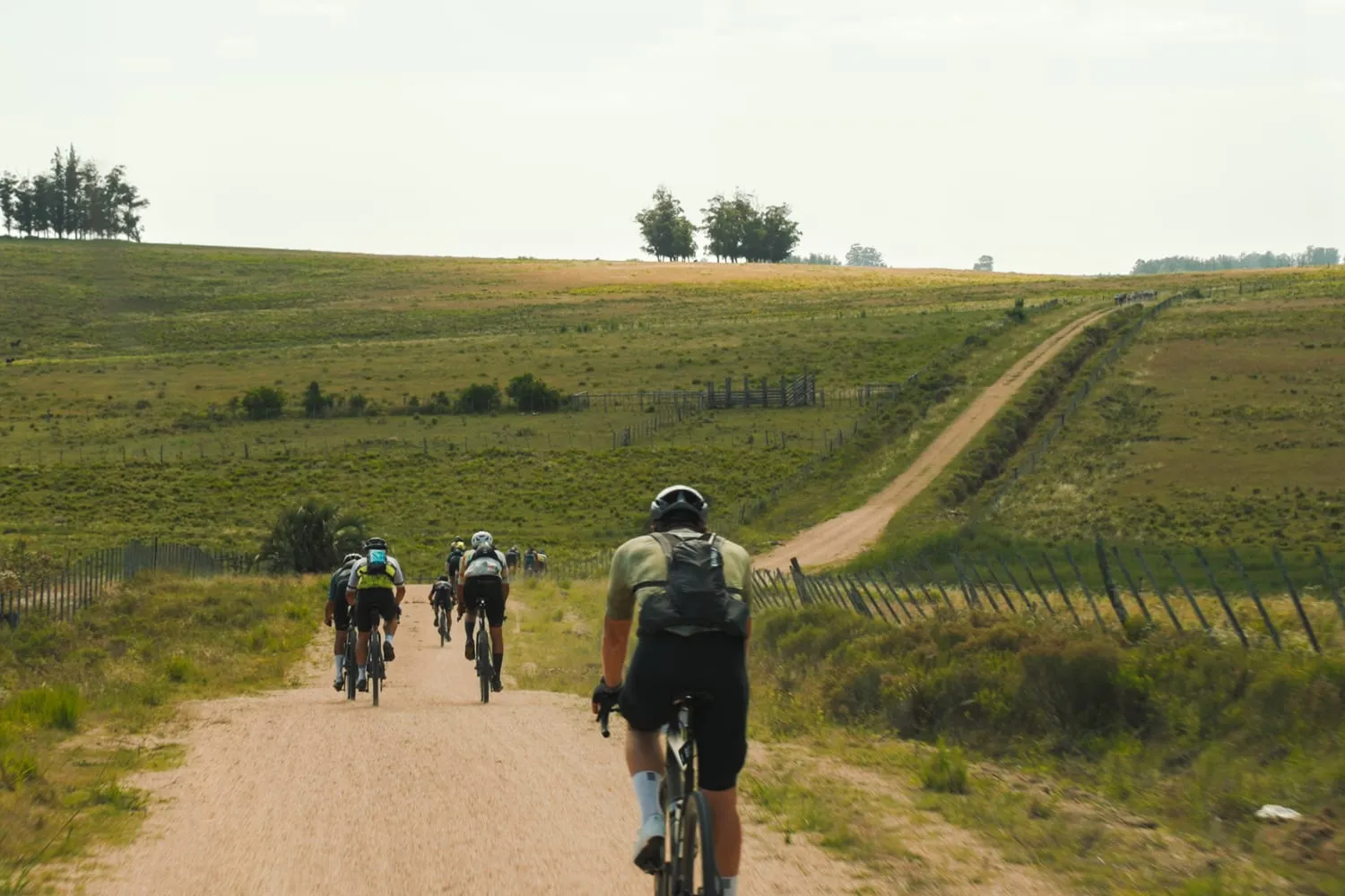 Two riders on the same gravel road, at different points
